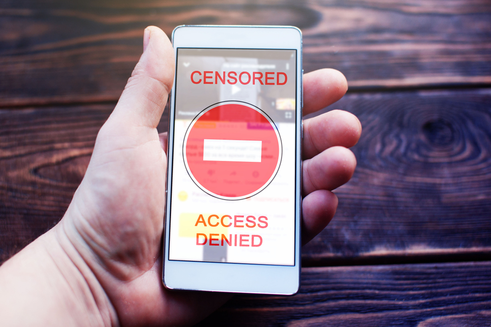Smartphone,In,Hand,With,The,Words,Censored,And,Access,Denied,